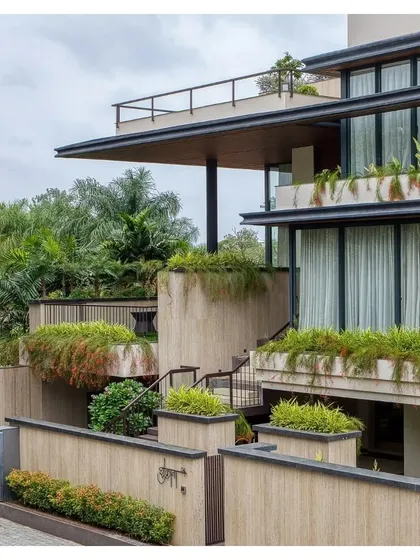 The overall composition of the Indore villa, with its deep overhangs and integrated greenery, is a powerful statement of modern residential design.