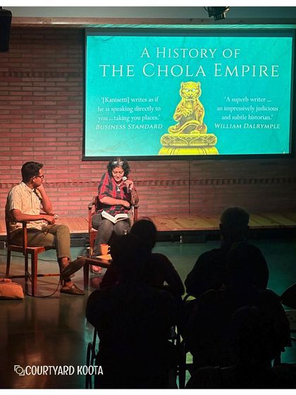 A view of the stage during the talk on the Chola Empire, with a slide showing the cover of Anirudh Kanisetti's book. Our talks often incorporate visuals to enrich the learning experience.