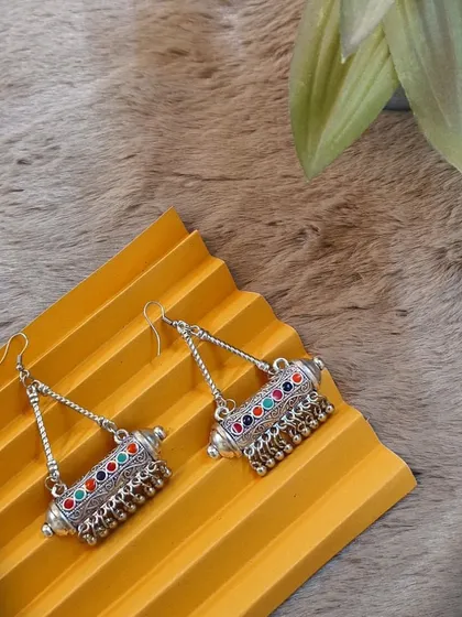 A still product shot of the multicolour embellished oxidised earrings, highlighting their unique cylindrical design and vibrant colours.