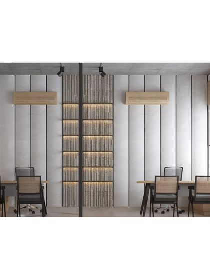 The detailing in this office space reflects a meticulous fusion of functionality and elegance. The color palette draws from natural materials, with wood bringing warmth and textured grey paneling adding depth.