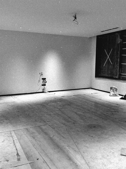 An empty room after the initial flooring and wall finishing, with spotlights being tested. This is the blank canvas stage where the lighting plan starts to take shape.