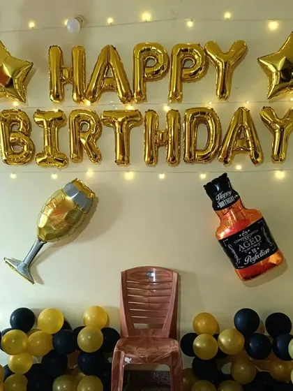 Here’s a classic and stylish birthday decoration that never fails to impress. This setup features gold 'Happy Birthday' foil balloons, star accents, and fun bottle and glass-shaped balloons, all set against a backdrop of yellow and black balloons. It’s a great theme for milestone birthdays.