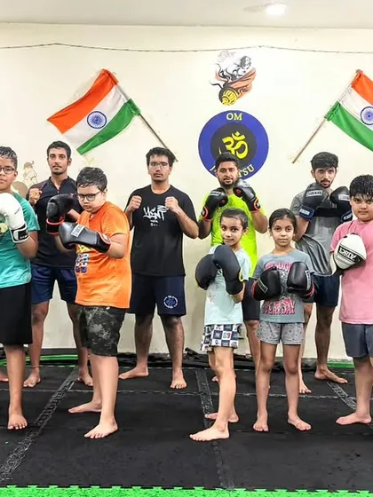 A more serious pose, but the same team spirit. Our students, both kids and adults, stand together, ready to train and grow.