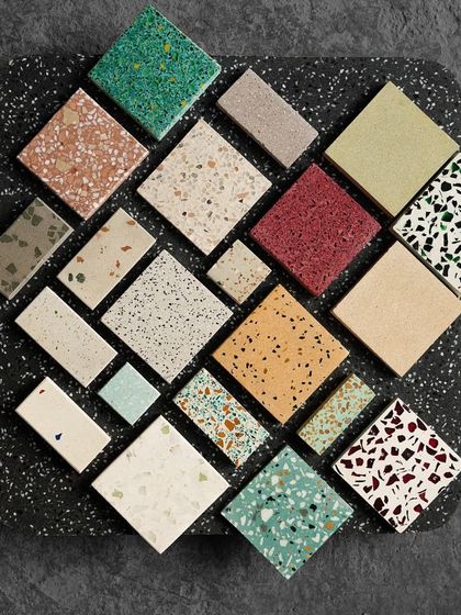 A large black terrazzo slab serves as the backdrop for a curated selection of our most popular and unique tile designs.