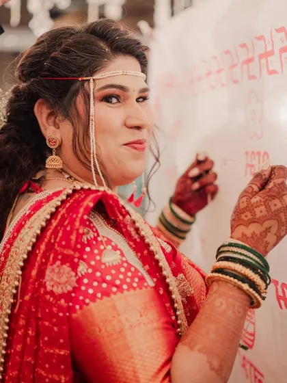 A playful glance from the bride during the wedding rituals. These are the small, personal moments that add so much character to a wedding album.