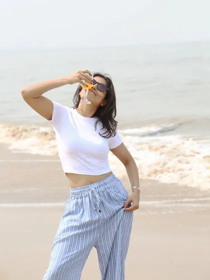 This playful shot adds a touch of fun and personality to the beach series. It’s a candid moment that breaks the mold of typical fashion poses and helps create a more relatable brand image.