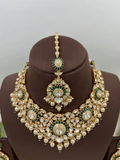The green version of the 'Zarista' set, featuring a necklace and maang tikka.