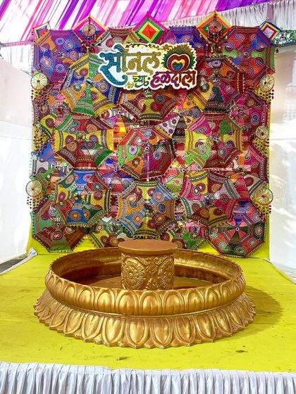 Personalization is key. For this Haldi, we created a custom sign in Marathi that reads 'Sonal cha Haldi Sohala' and placed it on a colorful backdrop made of decorative umbrellas, making the bride feel extra special.