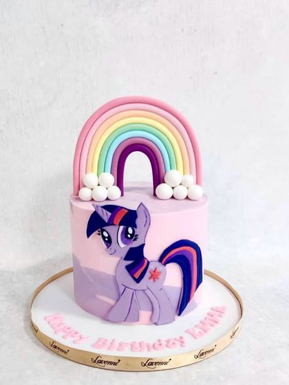 A My Little Pony cake featuring Twilight Sparkle. The cake is decorated with a big fondant rainbow and fluffy clouds.