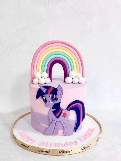 A My Little Pony cake featuring Twilight Sparkle. The cake is decorated with a big fondant rainbow and fluffy clouds.