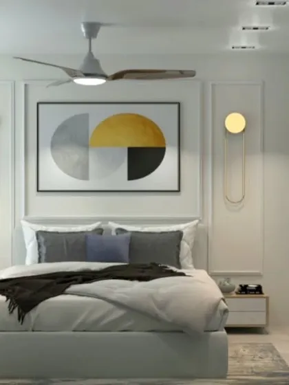 A bright and cheerful bedroom with yellow and grey accents. The design features elegant wall molding and modern gold-finished light fixtures.