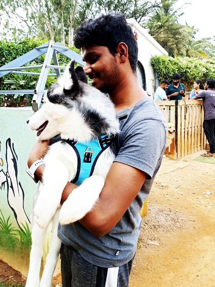 A visitor shares a smile with a beautiful Husky puppy.