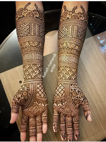 A beautiful and clean example of full hand bridal mehandi. The geometric patterns combined with floral elements give it a very rich and textured appearance, perfect for the modern bride.