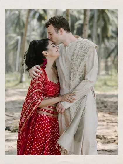 An intimate moment of love and tenderness. The groom's gentle kiss on the bride's forehead, set against a backdrop of lush palm trees, speaks volumes. These are the quiet, heartfelt moments I love to capture.