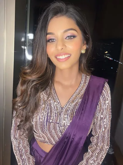 This close-up shows her radiant smile and the beautiful, soft-focus eye makeup. It's a fresh and modern look.