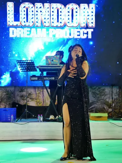 Feeling the music during a performance with the London Dream Project. I bring my soulful vocal style to every genre, including high-energy Bollywood sets.