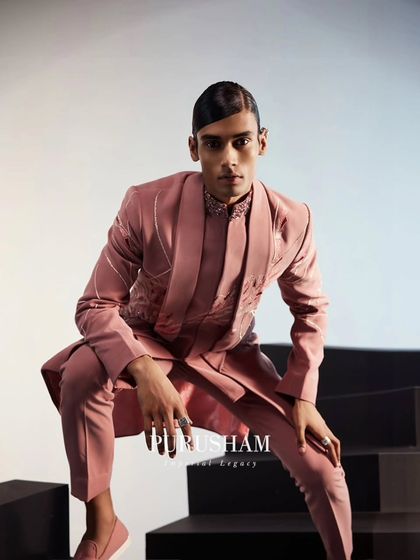 A powerful pose in this dusty rose fusion suit. The shawl lapel jacket features delicate, organic embroidery, creating a look that is both dapper and elegant.