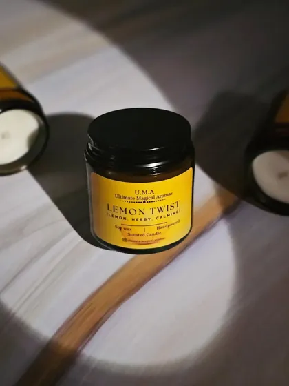 The 'Lemon Twist' candle from my Gourmand Collection, captured in dramatic lighting. The zesty and calming scent is perfect for creating a serene ambiance that helps you unwind.