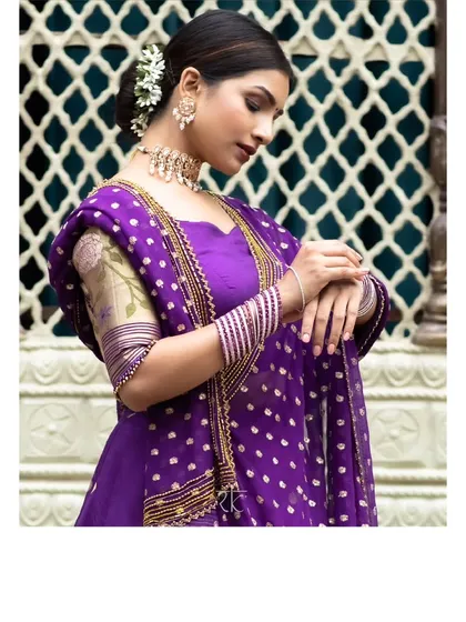 A portrait showcasing the Paithani lehenga set, highlighting the floral embroidery on the sleeves and the rich texture of the dupatta.