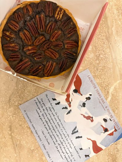 For La Croûte's first anniversary, I highlighted their famous pecan pie. This flat lay shot with the invitation card creates a narrative around the event and showcases one of their signature dessert offerings.