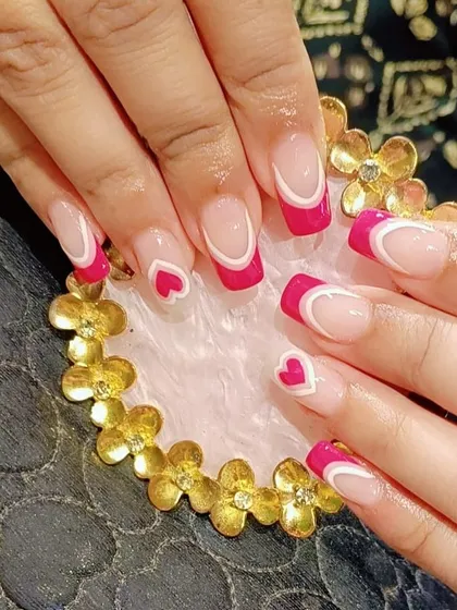 A playful and romantic design with bright pink French tips, white line details, and cute heart accents on square nails.