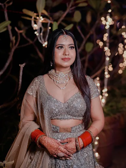 Our classic reception bride in a stunning Lalit Dalmia creation. The makeup is elegant and timeless, with a focus on glowing skin and defined eyes to complement her beautiful outfit.
