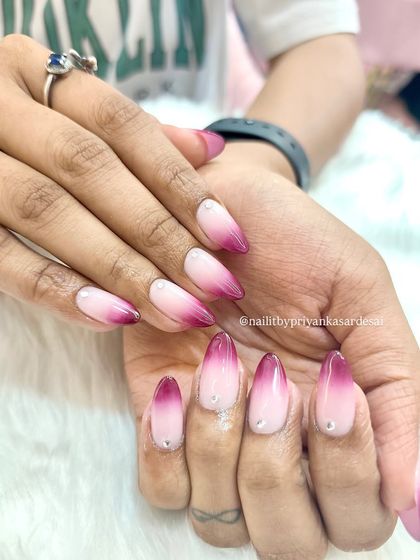 A bold and beautiful blush ombré set. These long almond nails feature a seamless gradient from soft pink to a deep magenta, with a tiny crystal accent at the cuticle.