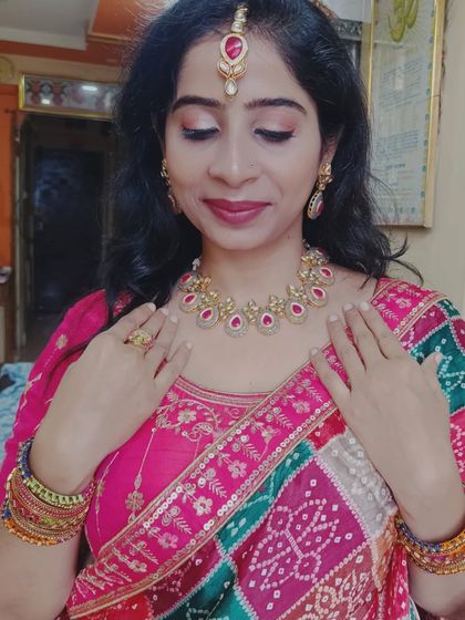 A close up of the Karwa Chauth look, showing the delicate ruby and gold necklace set that pairs beautifully with the pink outfit.