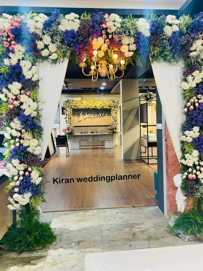 A closer look at the rich textures and colors of the floral entrance arch. The combination of deep blues, crisp whites, and fresh greens makes for a visually striking welcome.