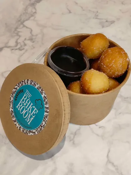 Our mini bombolone tubs. These bite-sized, flavor-packed pastries are perfect for a quick indulgence and come with a delicious chocolate dipping sauce.