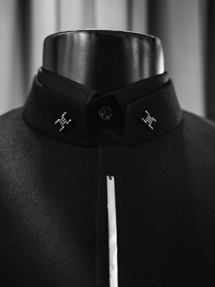 A look at the collar detail from our "Metal Bling" collection. The sharp, metallic accents provide a modern, almost military-inspired precision to the garment.