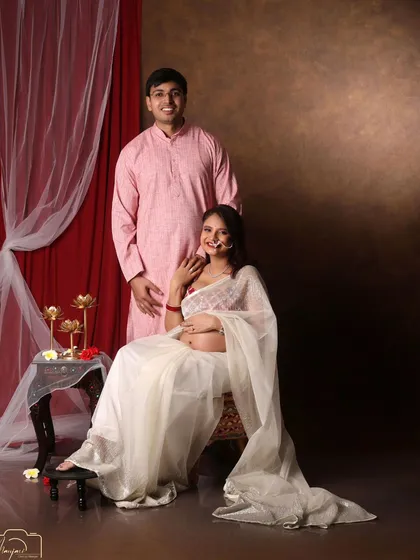 A beautiful seated portrait of the couple. The sheer white saree is elegant and unique.