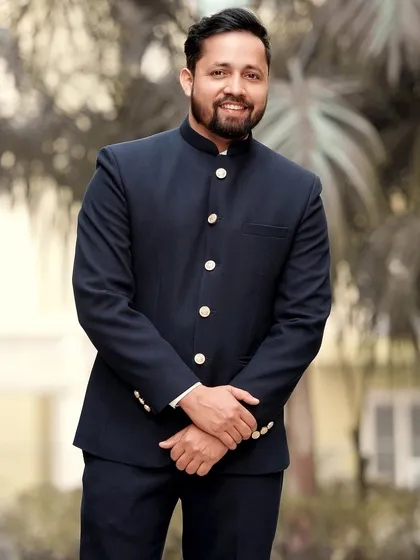 A classic and happy portrait of the groom. His smile and smart attire show he's ready for the celebration.