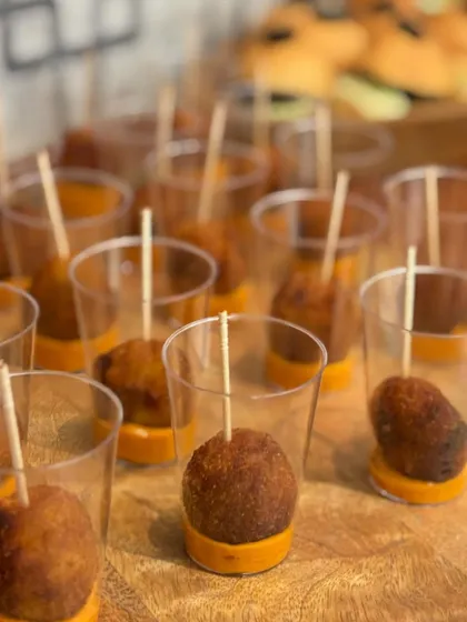 Quinoa and cheese balls served in individual shot glasses with a savory dip. A healthy yet indulgent appetizer option for the guests at Beau Monde Clinics.