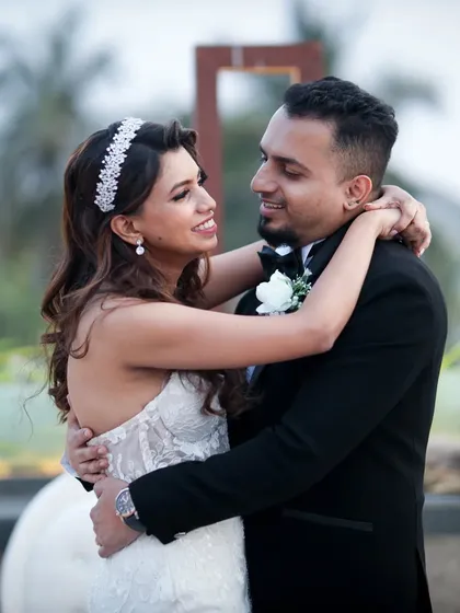 A joyful, candid embrace between a newly married couple. This photo from a Christian wedding captures the pure happiness and love they share right after their ceremony.