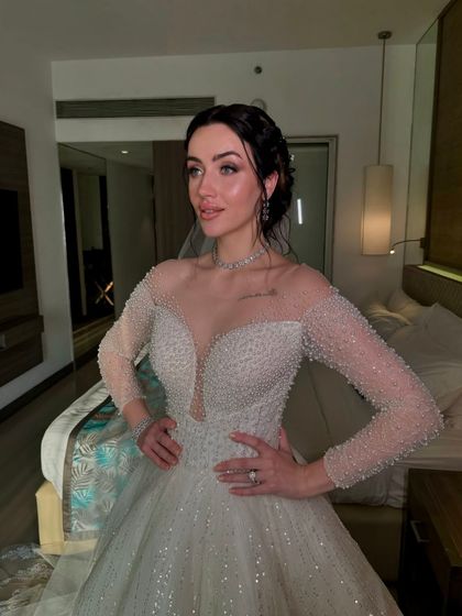 Another portrait of this stunning bride in her white gown, showcasing the soft, romantic makeup.