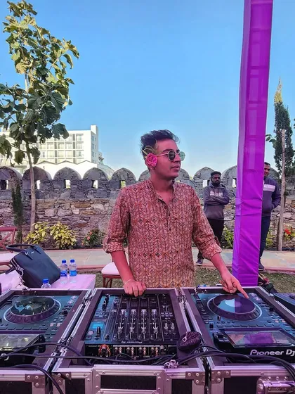 DJing outdoors at a beautiful venue in Udaipur. I adapt my music style to fit the daytime vibe, creating a relaxed yet energetic atmosphere perfect for a Haldi or Mehendi.