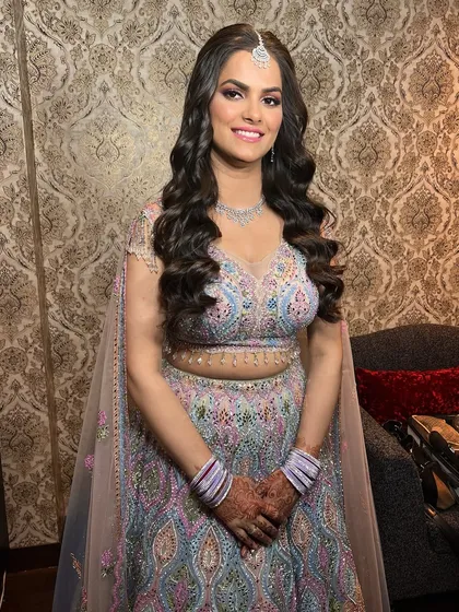 The complete look is pure perfection. The pastel lehenga, diamond jewelry, and pink-toned makeup come together for a stunning pre-wedding or reception style.