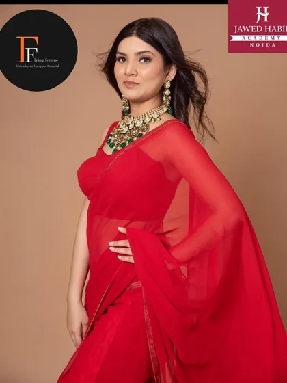 A close up of the model, highlighting the flawless makeup that complements the vibrant red outfit.