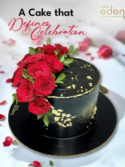 A cake that defines celebration. This stunning black cake is decorated with a cascade of fresh red roses and a sprinkle of gold dust, creating a dramatic and romantic statement piece.