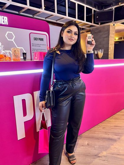 My full outfit and look for the Huda Beauty Easy Blur foundation launch. I'm holding the product that helped me achieve this flawless, filter-like skin finish.