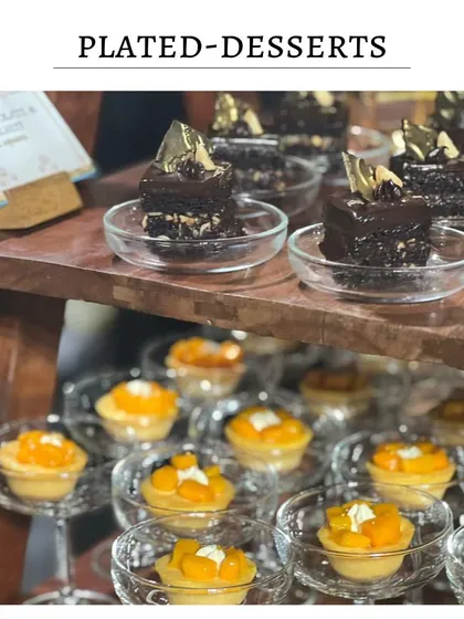 A dessert display featuring two of my popular options: mini mango tarts and dark chocolate and hazelnut cake squares. This offers guests a choice between fruity and rich.
