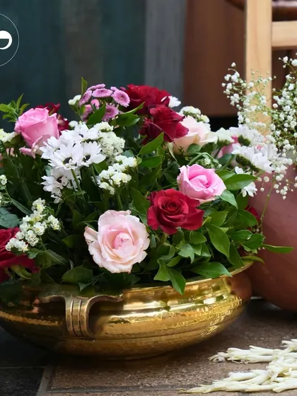 For a traditional 'Seemant' ceremony, we used classic decor elements like hammered brass bowls filled with beautiful pink and red roses. This created an atmosphere of timeless elegance and warmth.