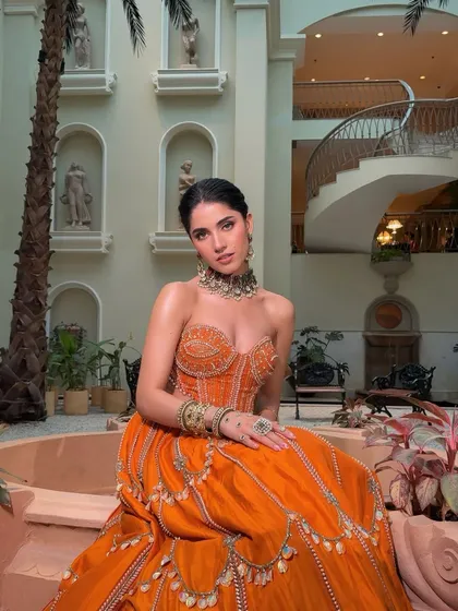 For a vibrant Mehendi or Sangeet, we created this stunning boho-glam look. The makeup is breezy yet impactful, with a dewy base, a fresh flush of peachy warmth, and striking earthy tones on the eyes that are perfect for dancing under fairy lights.