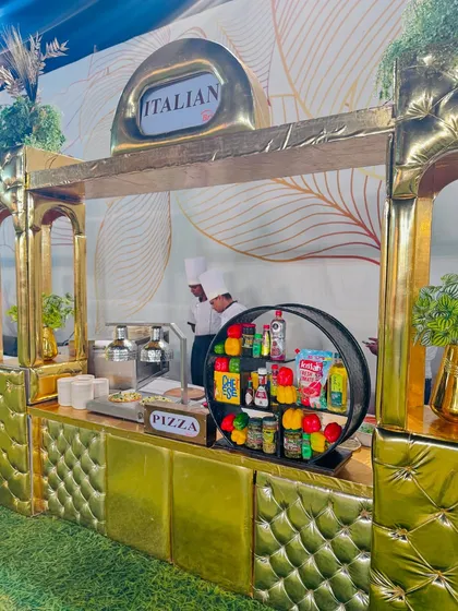 A side view of the luxurious golden Italian pizza station, showcasing its intricate design and professional setup.