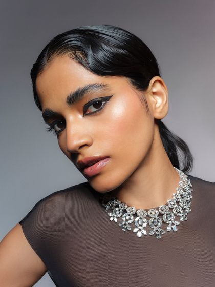 A classic portrait for a diamond jewelry campaign. The styling with a sheer black top allows the brilliant diamond necklace to stand out as the hero piece.