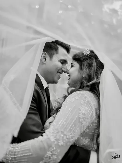 A timeless black and white portrait. This classic shot under the veil captures the intimacy and romance of a Catholic wedding, showing our ability to create artistic and elegant images.