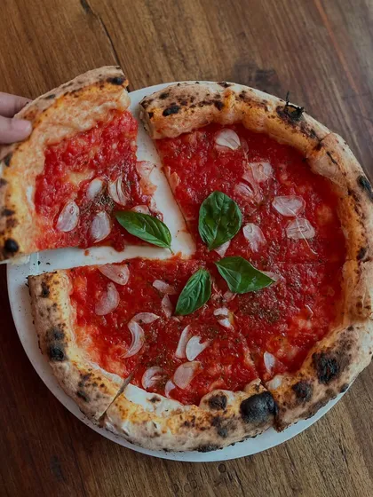 Diving into pizza perfection, one slice at a time with our classic Marinara.