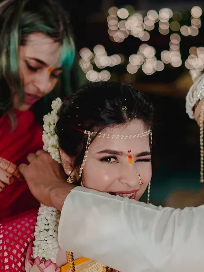 A playful wink during the ceremony. This candid moment captures her fun personality, with her traditional makeup looking flawless even in motion.