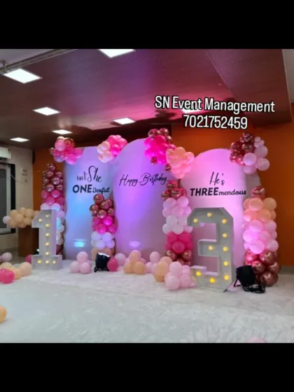 A stylish setup for a joint birthday party. The three arch backdrops with custom text and light-up numbers create a unique and personalized stage for the celebration.